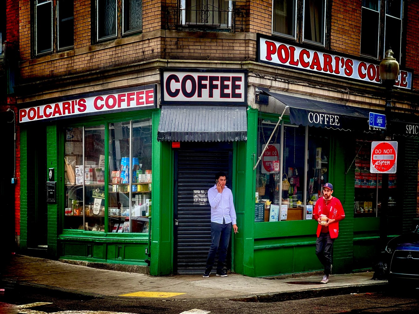 a group of people walking in front of a store