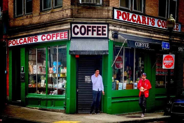 a group of people walking in front of a store