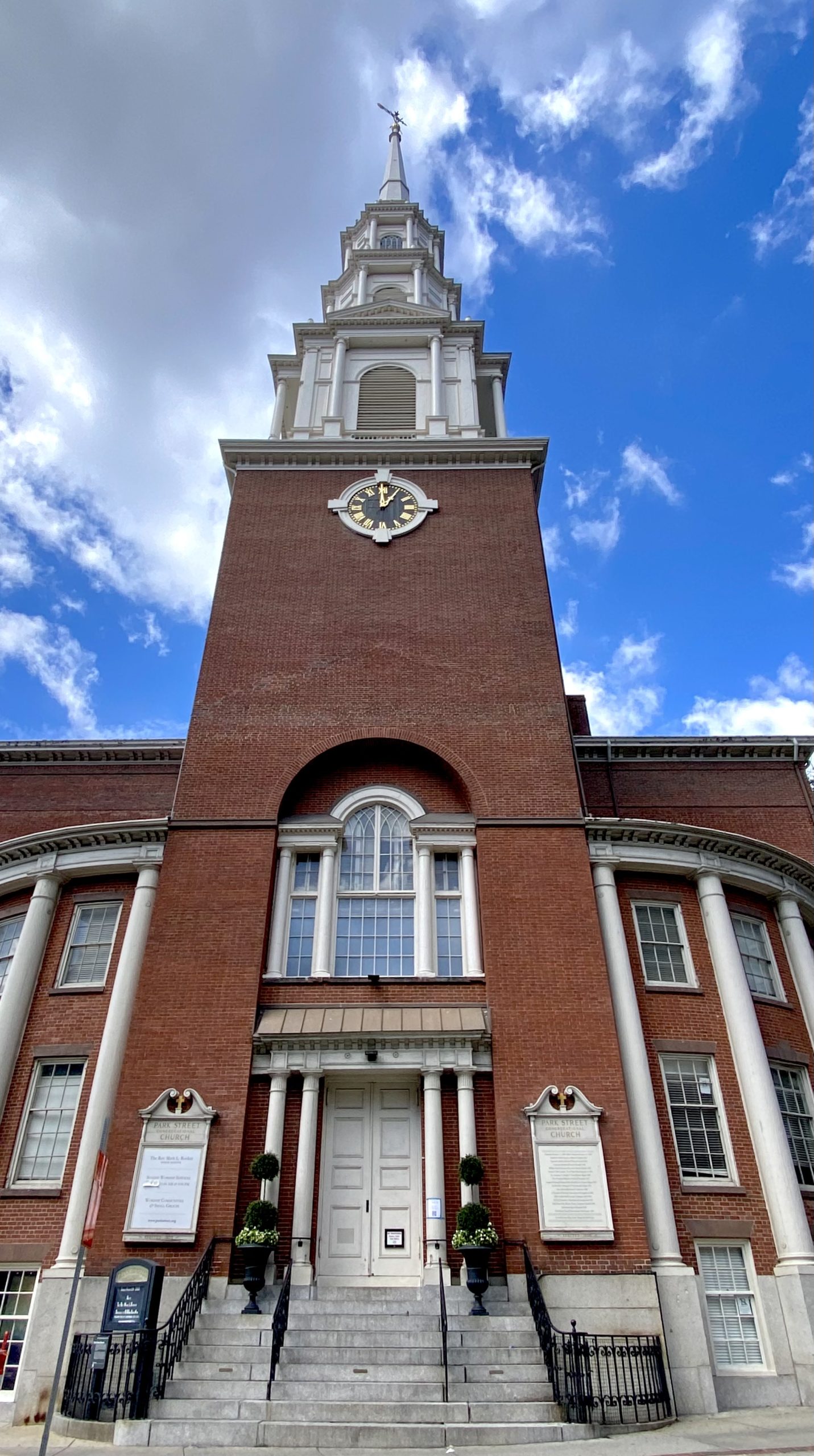 a clock tower in front of a brick building