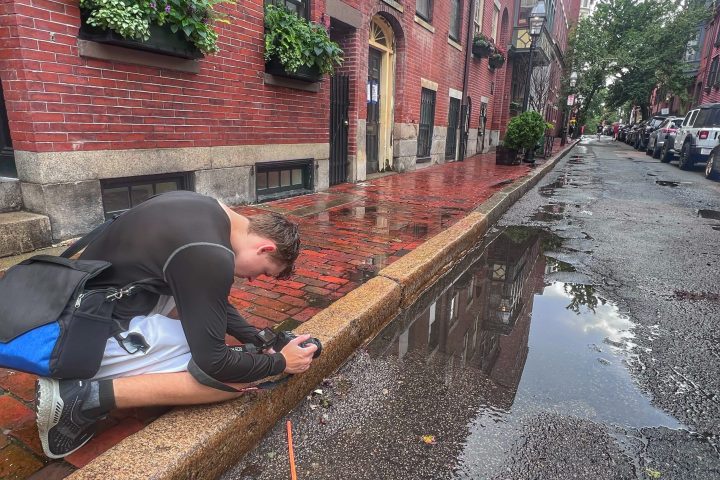 a man sitting on the side of the road