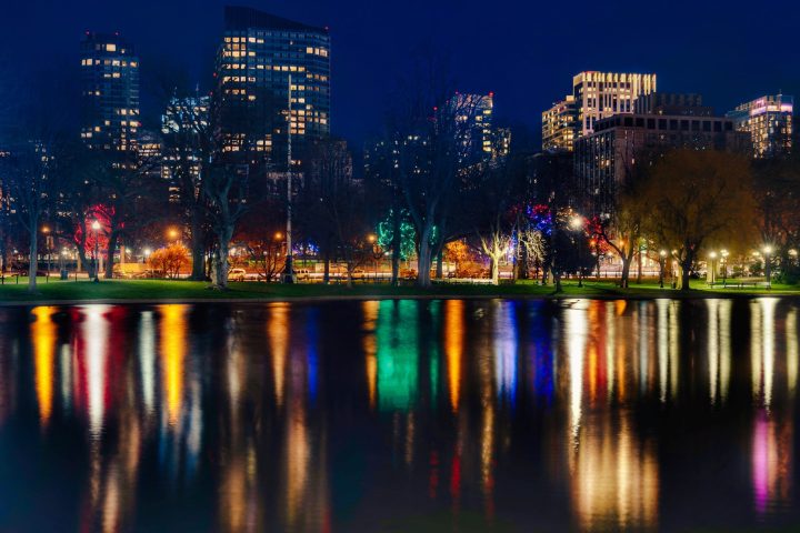 a body of water with a city in the night sky