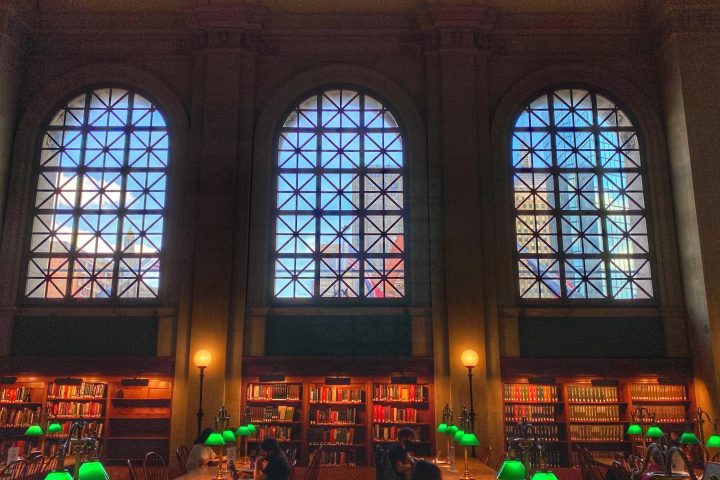 a group of people on a stage in front of a window