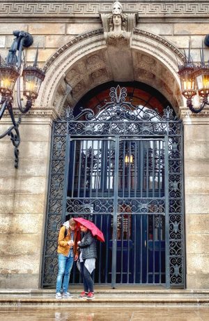 a statue of a person walking in front of a building